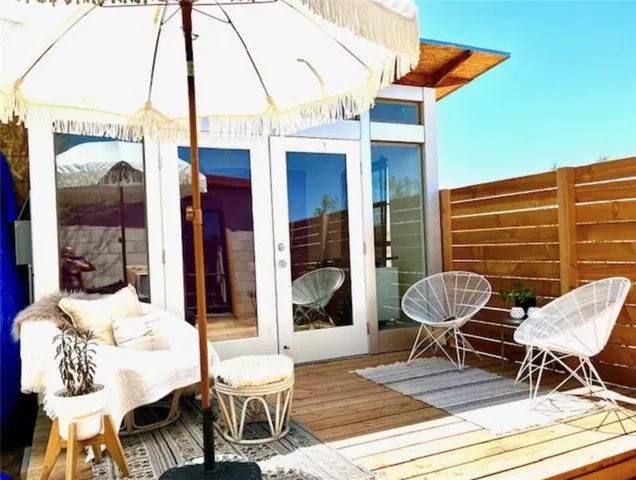 a view of a patio with a table and chairs