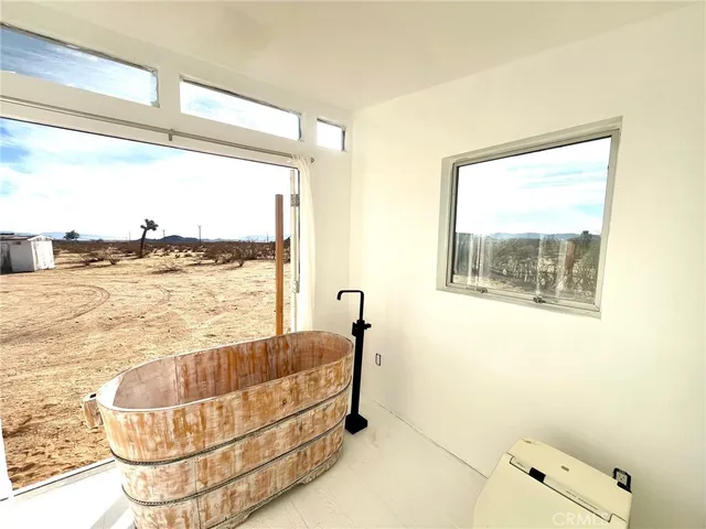 a living room with a table and a large window