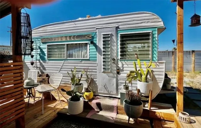 a view of a patio with dining table and chairs