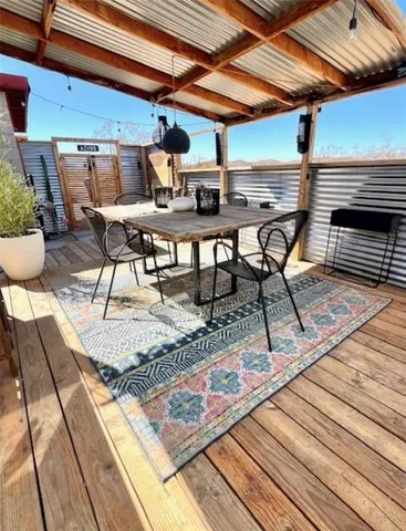 a view of a patio with table and chairs and potted plants