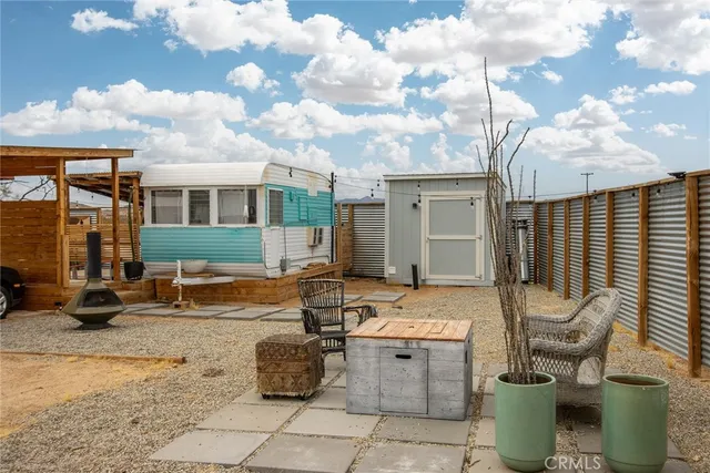 a backyard of a house with yard fire pit and outdoor seating