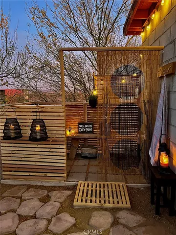 a view of a patio with table and chairs with wooden floor and fence