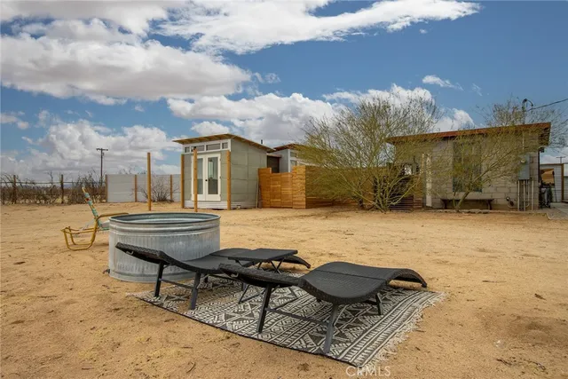a view of a chairs and table in backyard