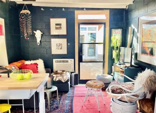 a bedroom with furniture and a large window