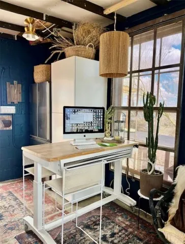 a kitchen with a table chairs and a window