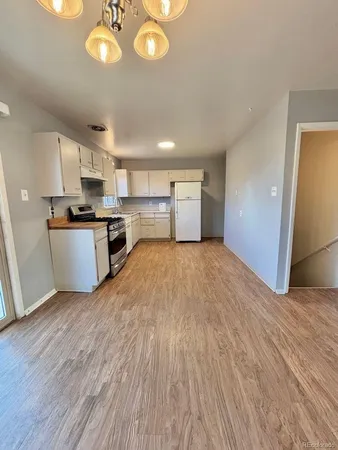 a view of a kitchen with a sink cabinets and wooden floor