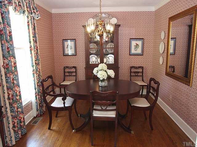 8609 Maidstone Court Raleigh, NC 27613 - Photo 3 of 12 a view of a dining room with furniture and chandelier