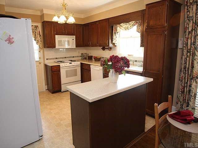 8609 Maidstone Court Raleigh, NC 27613 - Photo 4 of 12 a kitchen with kitchen island a sink appliances and cabinets