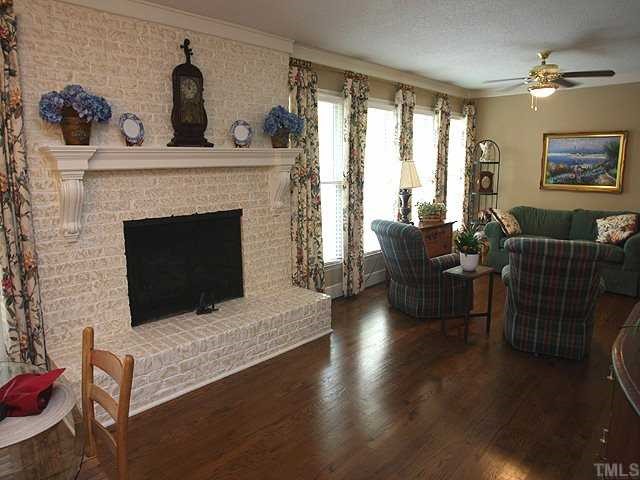 8609 Maidstone Court Raleigh, NC 27613 - Photo 6 of 12 a living room with furniture large window and fireplace
