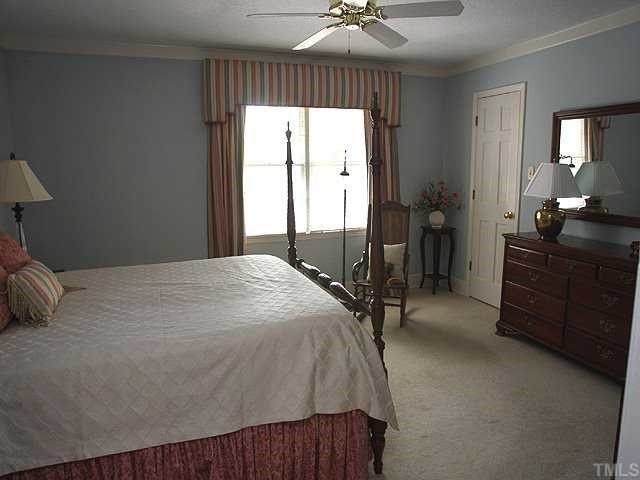 8609 Maidstone Court Raleigh, NC 27613 - Photo 7 of 12 a bedroom with a bed and a dresser