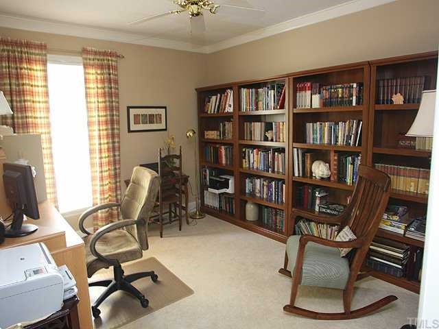 8609 Maidstone Court Raleigh, NC 27613 - Photo 9 of 12 a view of a workspace with a bookshelf and a chair