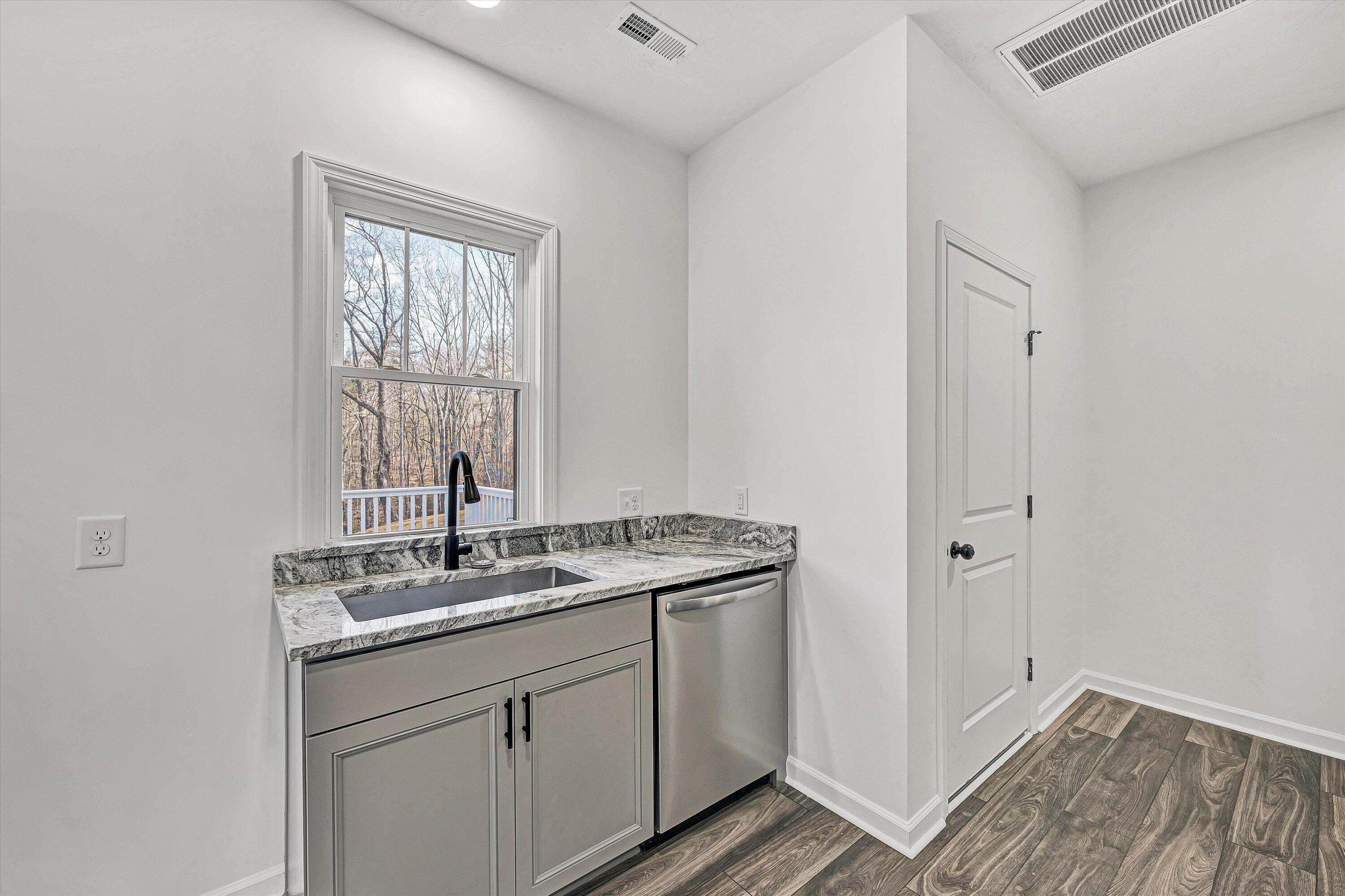 103 Bluff Court Moneta, VA 24121 - Photo 12 of 63 a bathroom with a granite countertop sink a mirror and a window