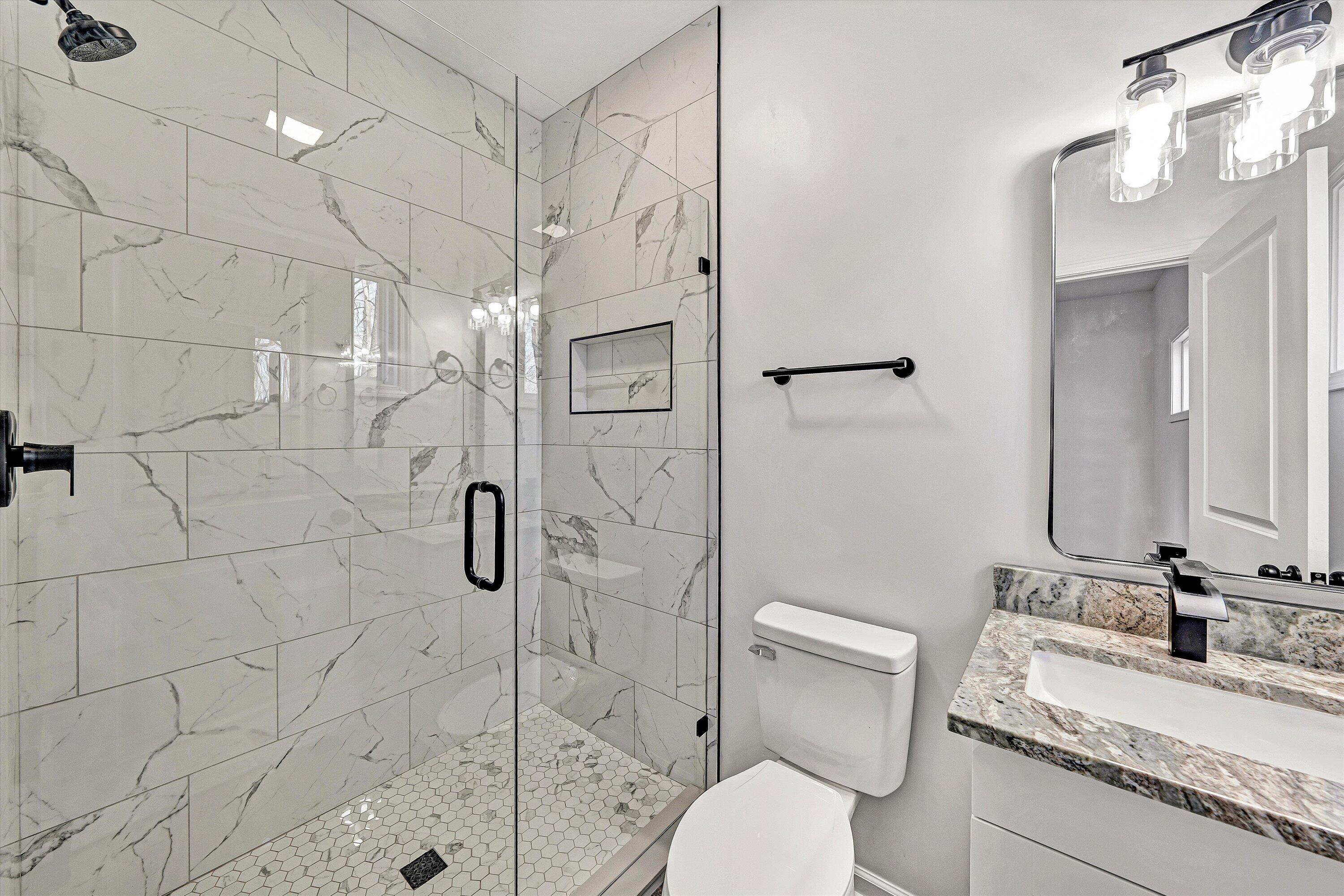 103 Bluff Court Moneta, VA 24121 - Photo 23 of 63 a bathroom with a granite countertop sink a toilet and shower