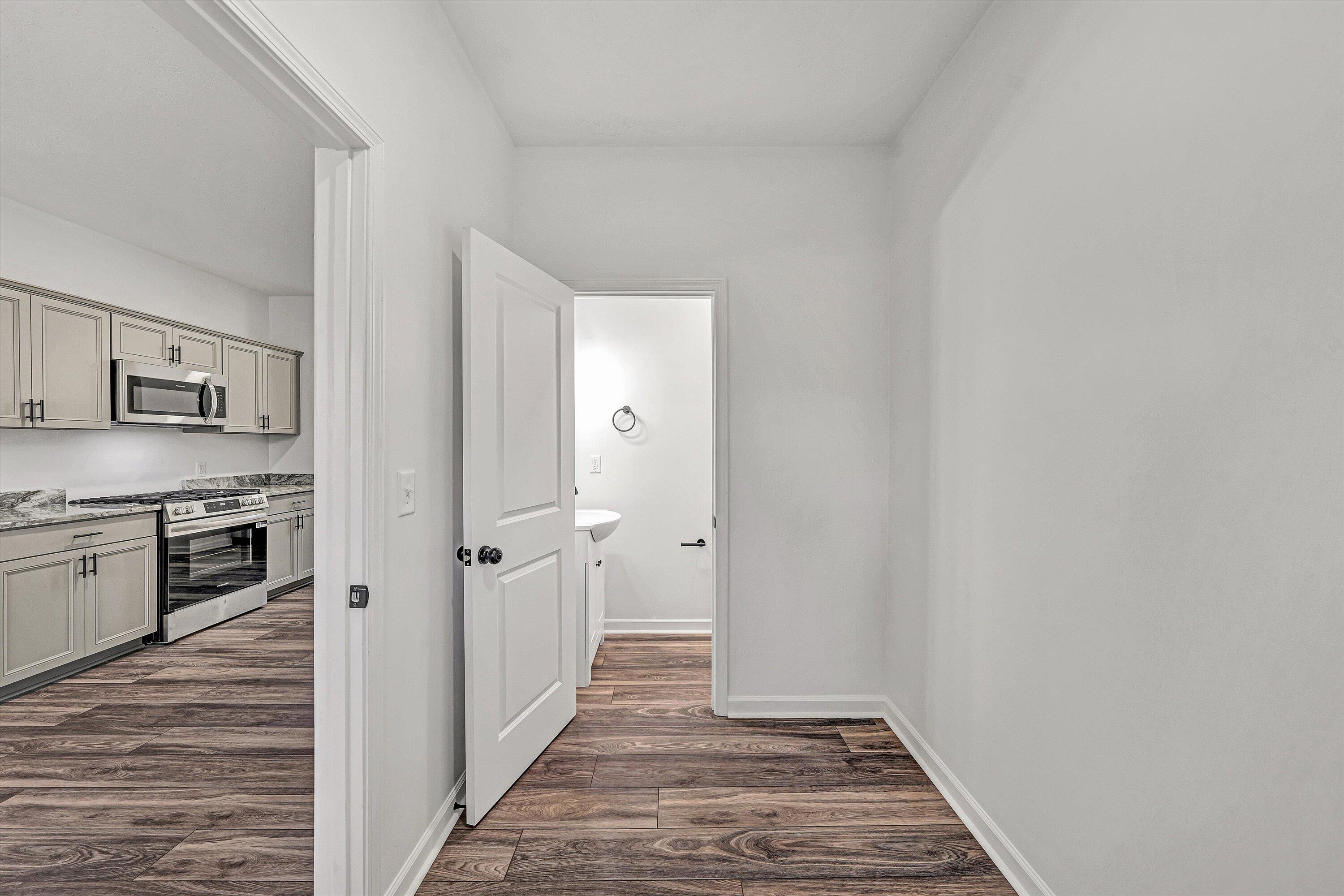 103 Bluff Court Moneta, VA 24121 - Photo 26 of 63 a view of a hallway with wooden floor and a refrigerator