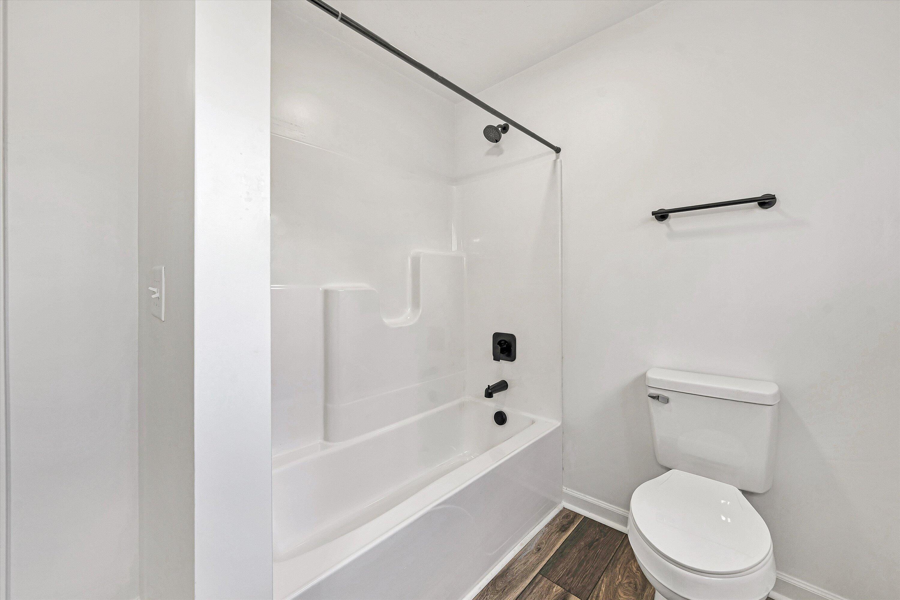 103 Bluff Court Moneta, VA 24121 - Photo 34 of 63 a white toilet sitting next to a bath tub