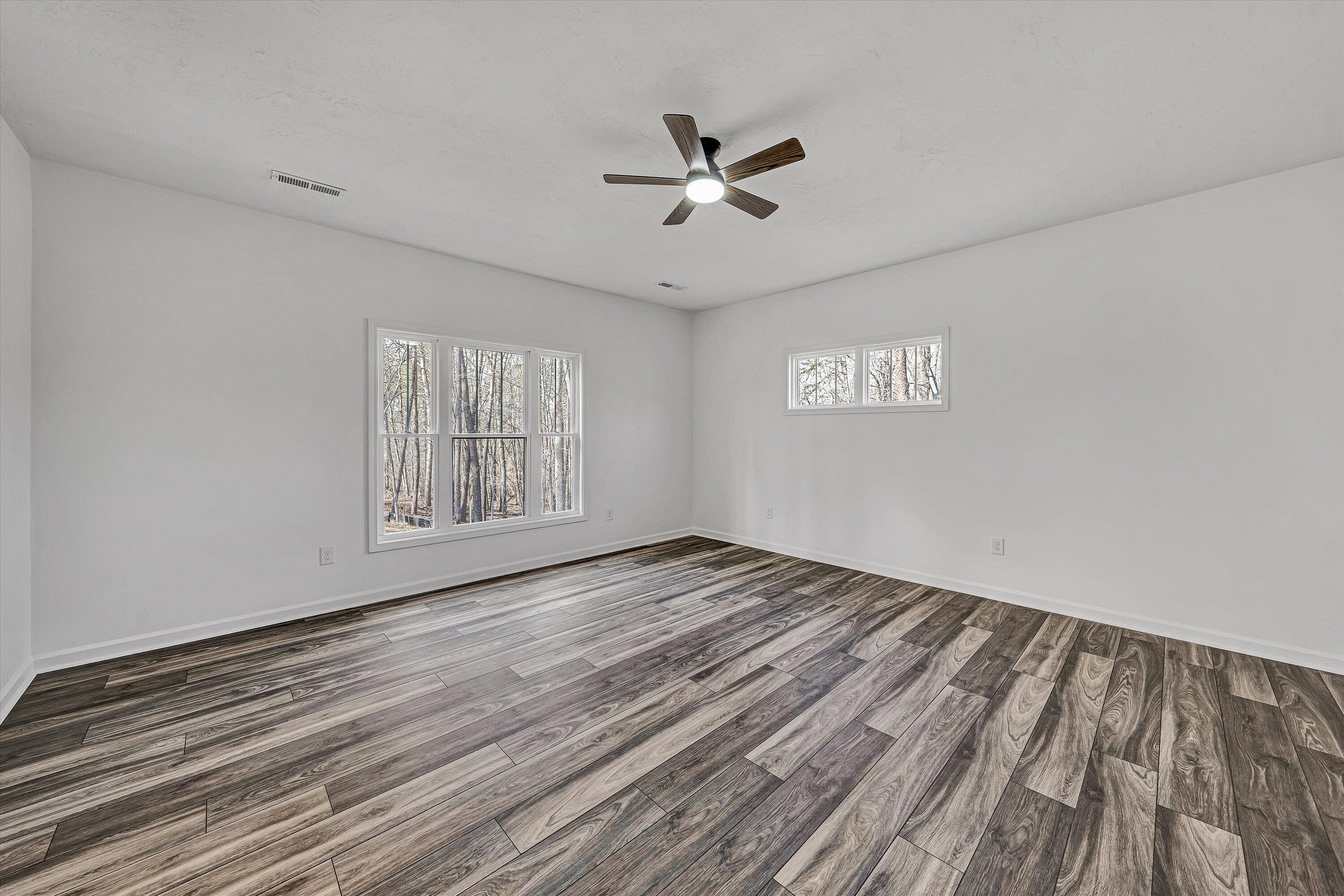 103 Bluff Court Moneta, VA 24121 - Photo 4 of 63 a view of an empty room with a window and wooden floor