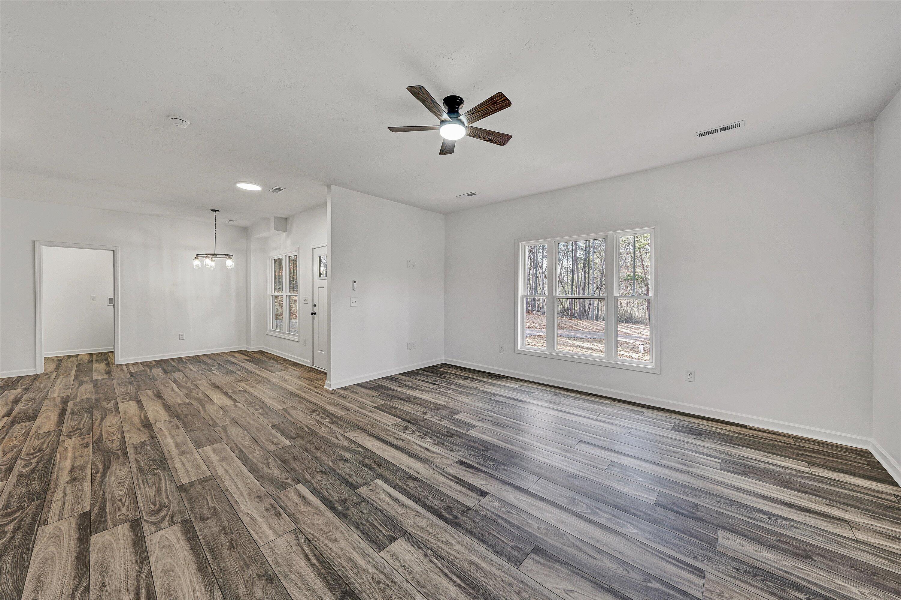 103 Bluff Court Moneta, VA 24121 - Photo 6 of 63 a view of an empty room with wooden floor and a window