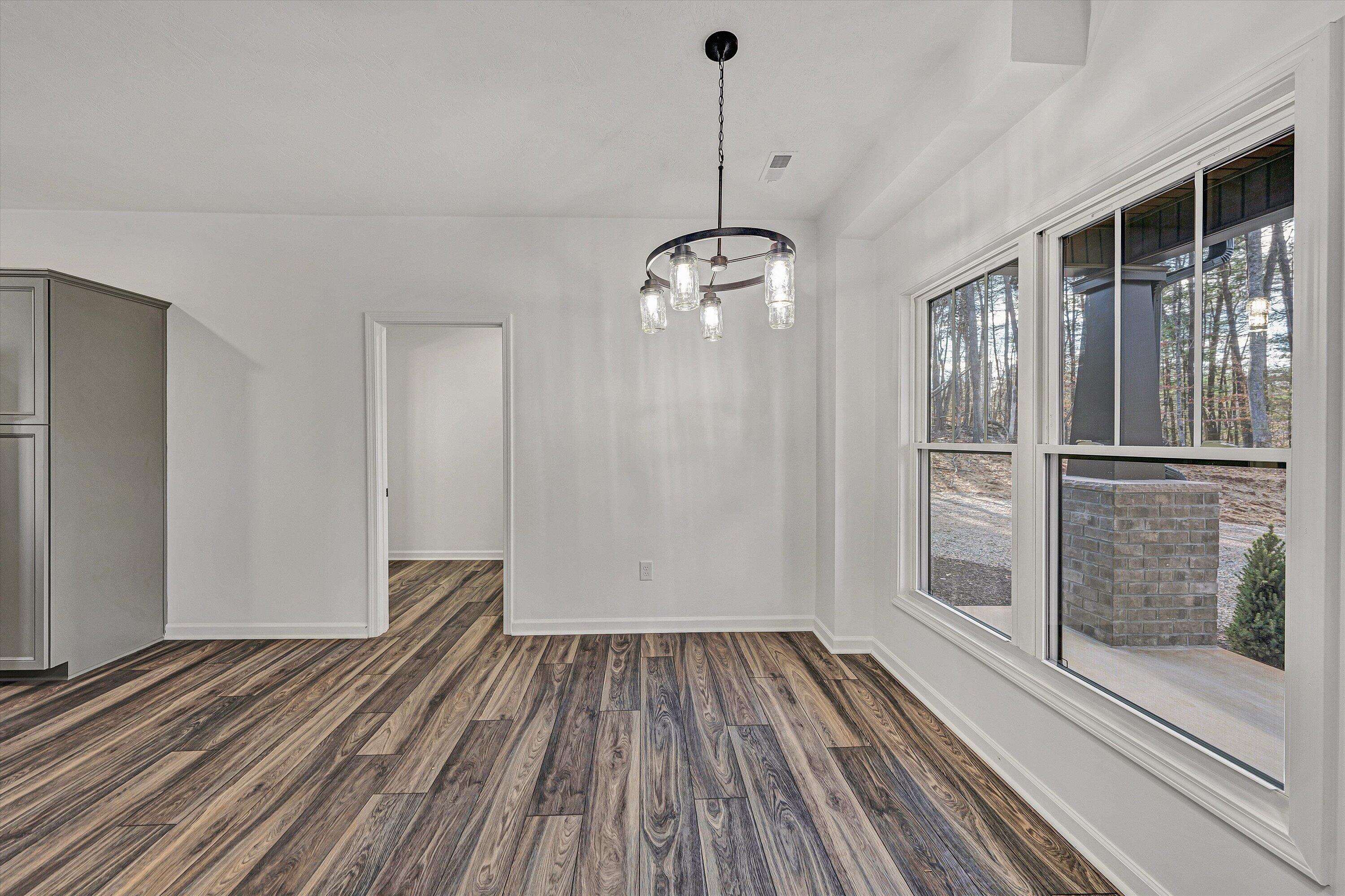 103 Bluff Court Moneta, VA 24121 - Photo 8 of 63 a view of empty room with wooden floor and fan