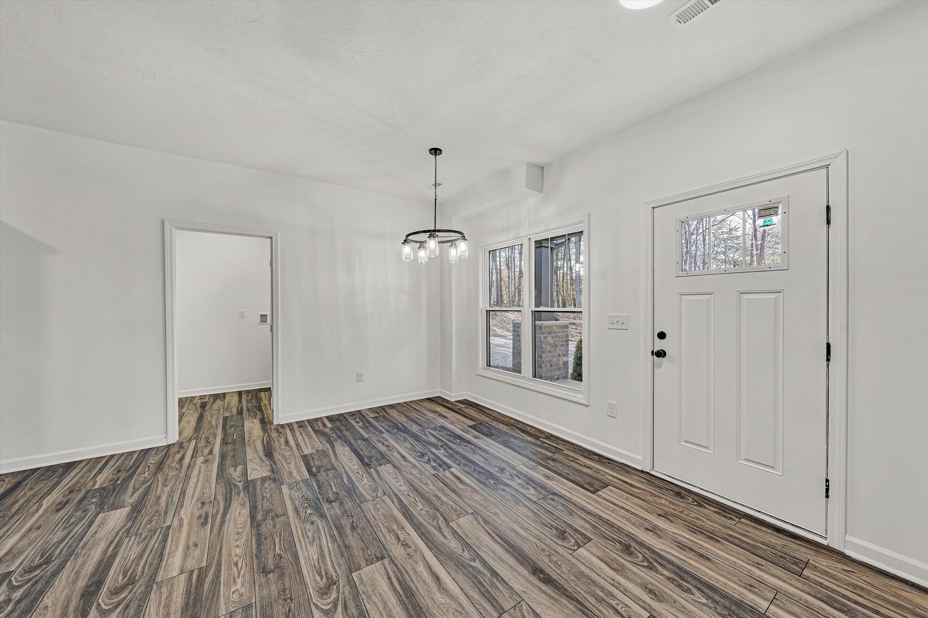 103 Bluff Court Moneta, VA 24121 - Photo 9 of 63 a view of an empty room with wooden floor and a window