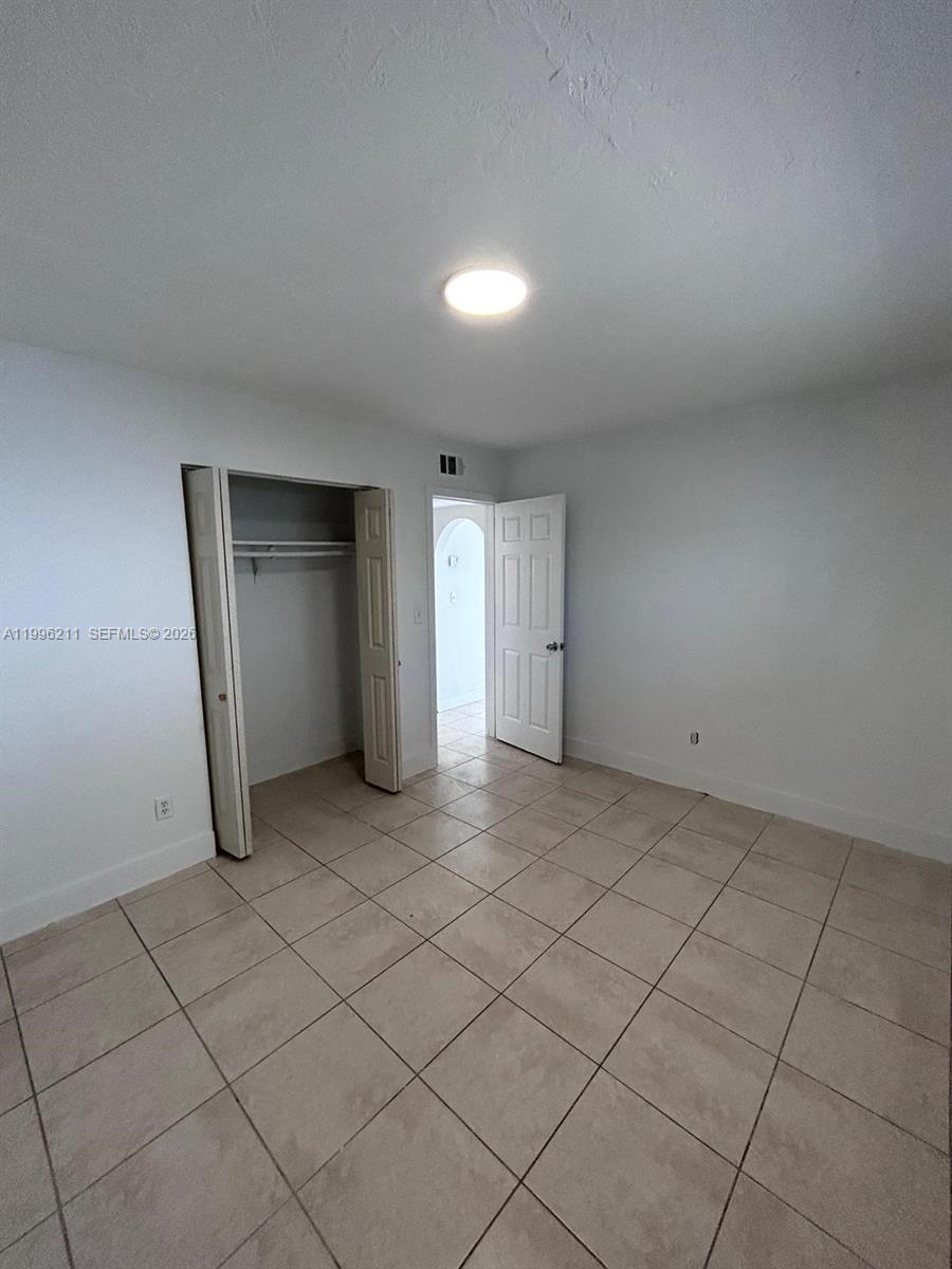 1128 Northwest 76th Street Miami, FL 33150 - Photo 16 of 25 an empty room with a fireplace