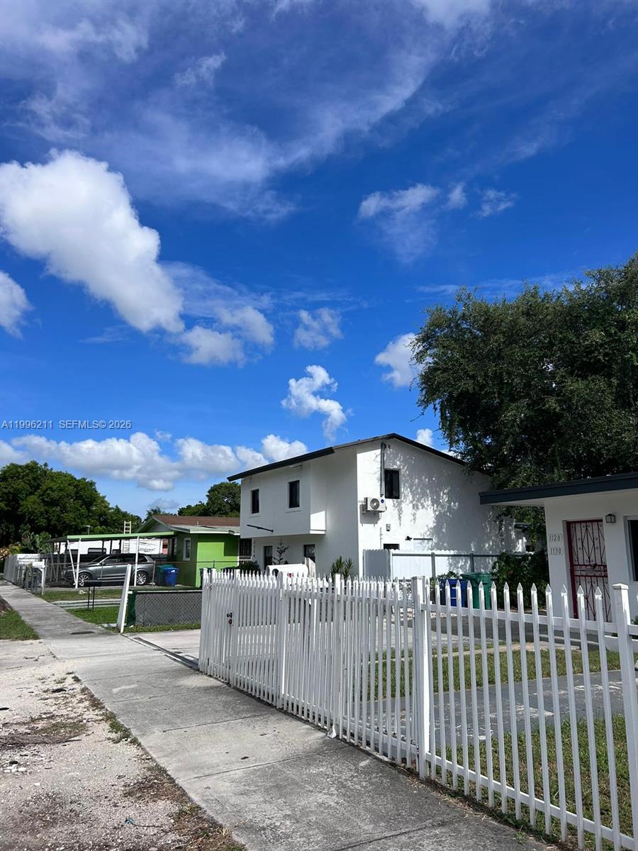 1128 Northwest 76th Street Miami, FL 33150 - Photo 23 of 25 a view of a wrought iron fences in front of house