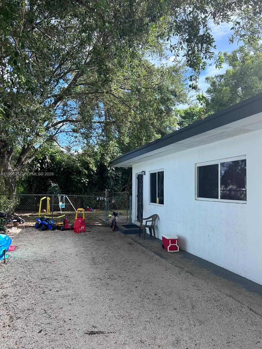 1128 Northwest 76th Street Miami, FL 33150 - Photo 5 of 25 a view of car parked in front of house