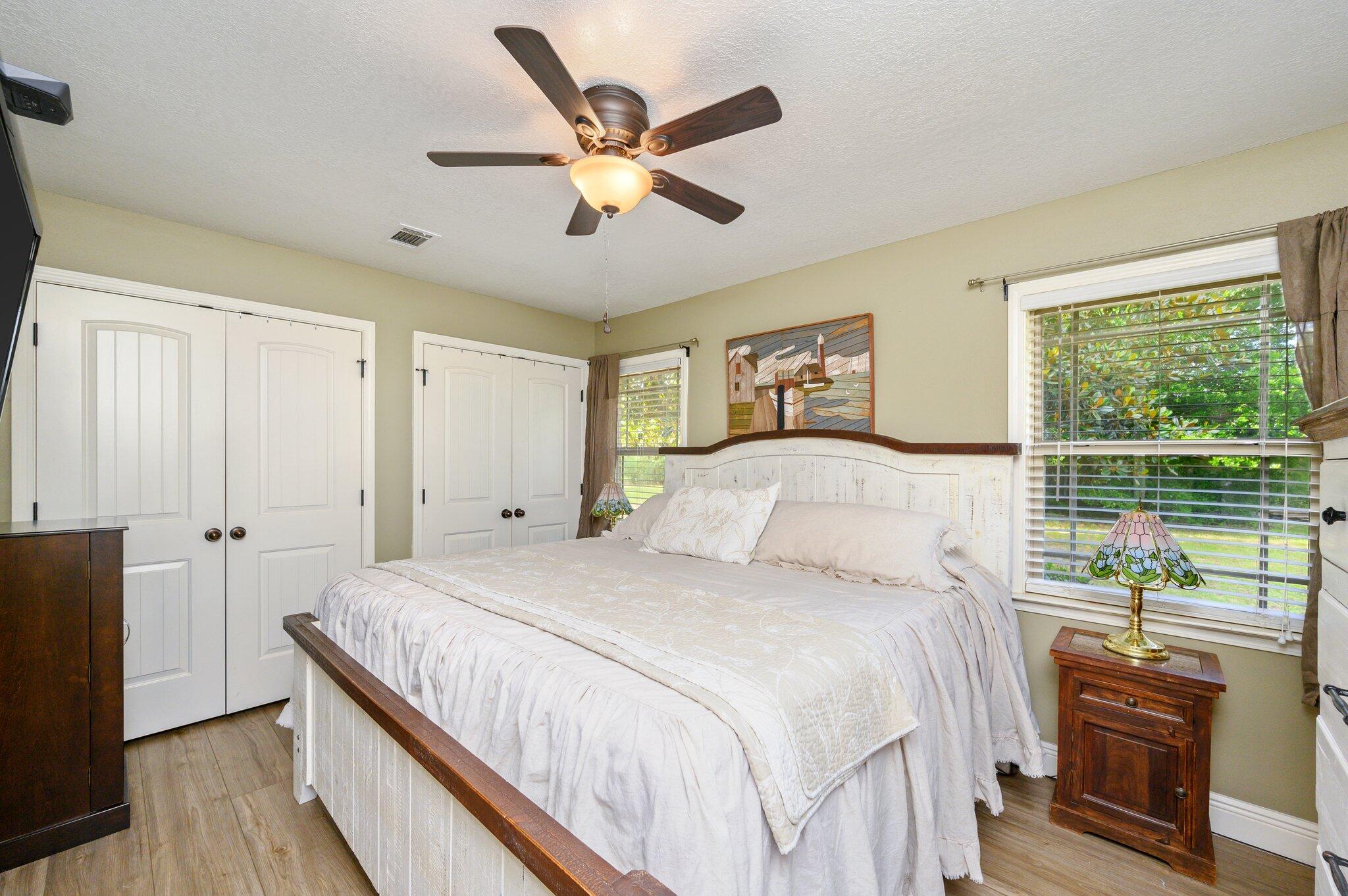 4082 Painter Branch Road Crestview, FL 32539 - Photo 15 of 49 a bedroom with a large bed and a large window