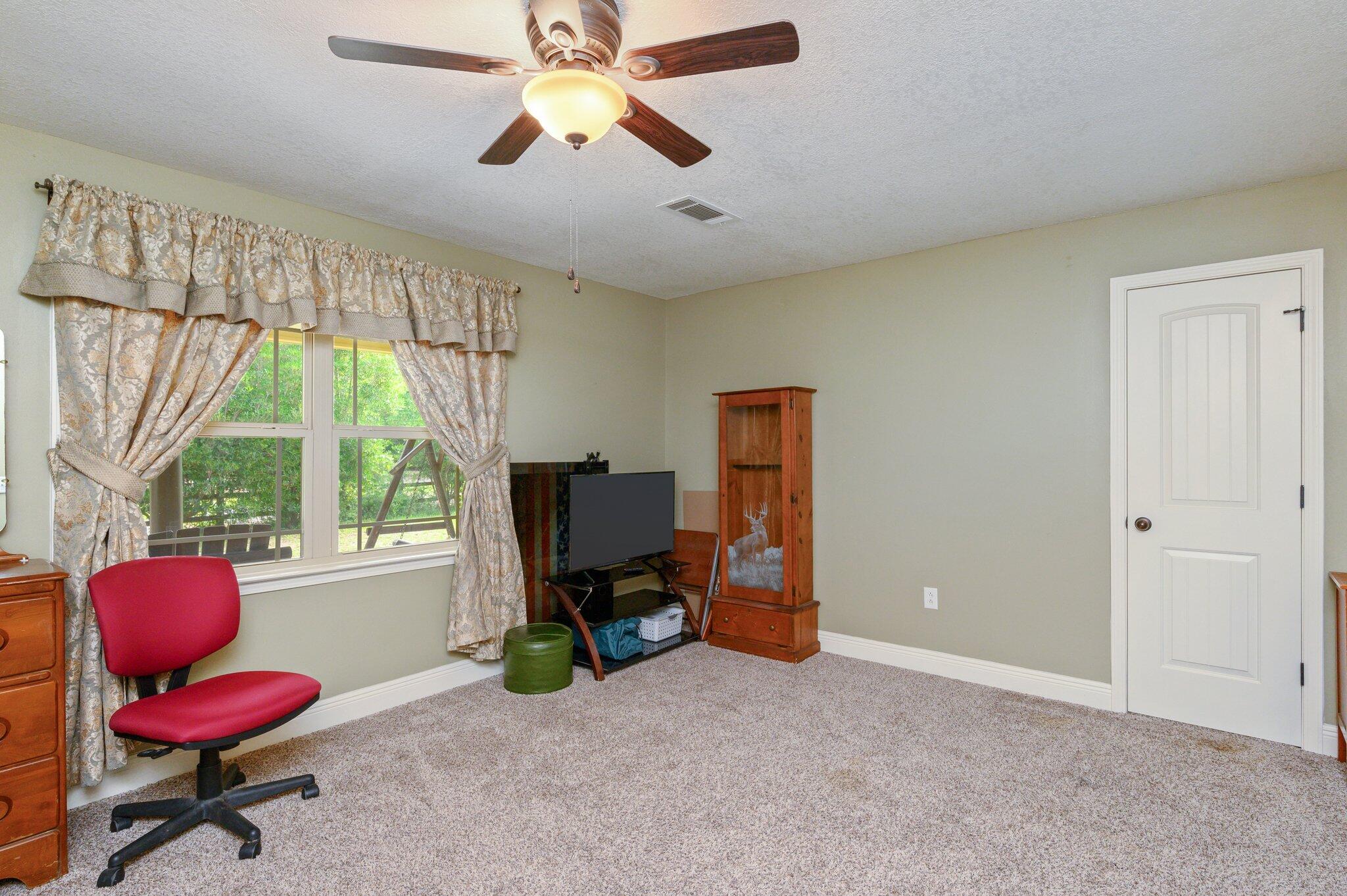 4082 Painter Branch Road Crestview, FL 32539 - Photo 23 of 49 a view of a workspace with furniture and a window