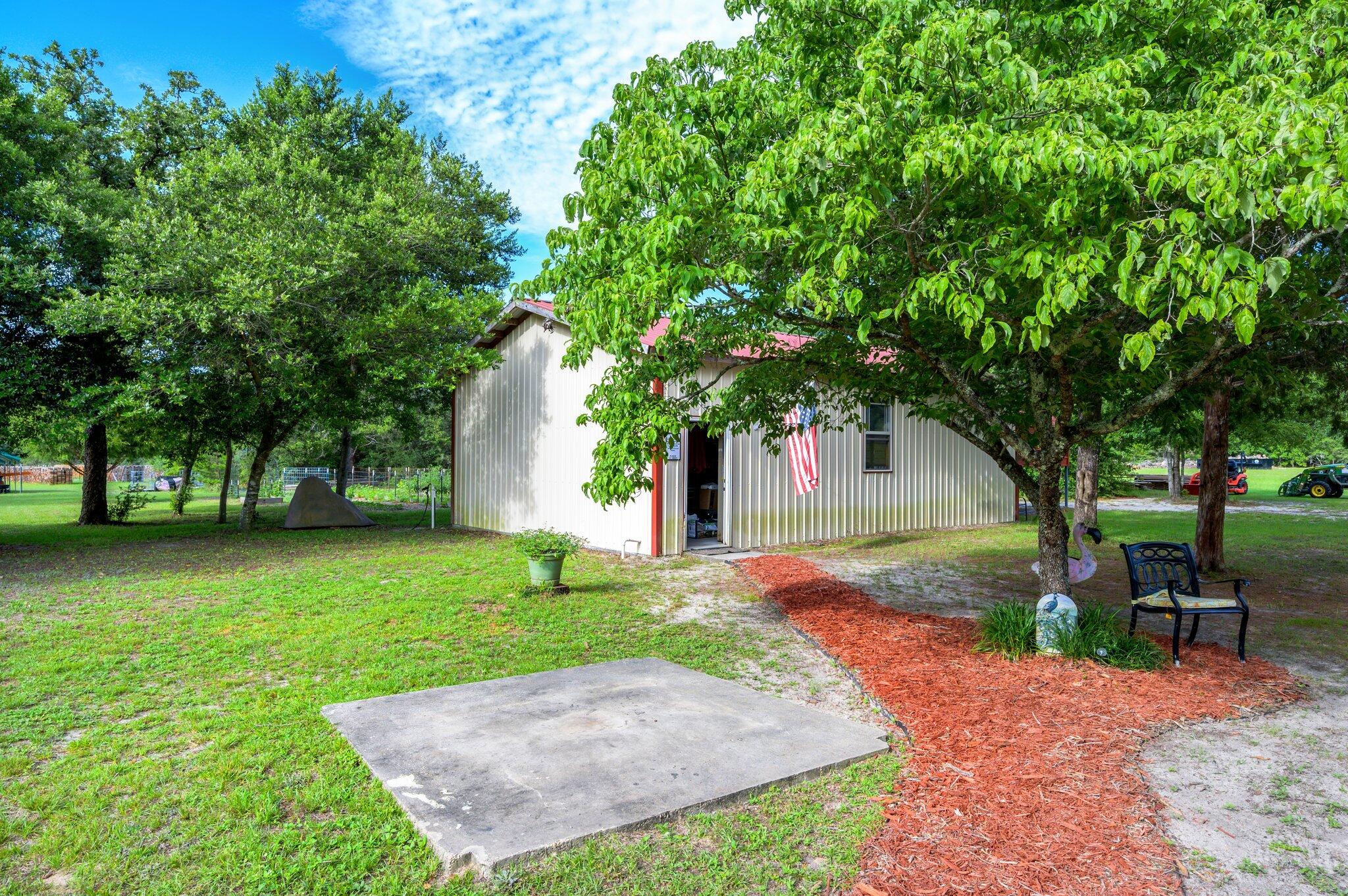 4082 Painter Branch Road Crestview, FL 32539 - Photo 36 of 49 a view of a backyard with a garden
