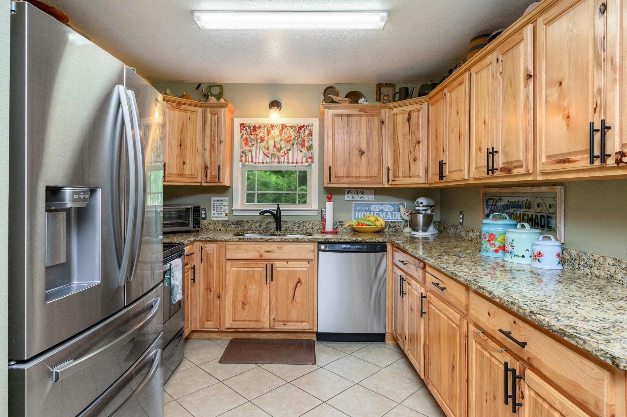 4082 Painter Branch Road Crestview, FL 32539 - Photo 10 of 49 a kitchen with granite countertop a sink stainless steel appliances and cabinets