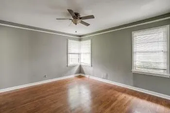 a view of a livingroom with a ceiling fan and window