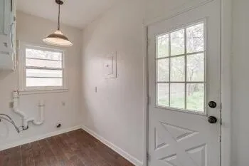 a bathroom with a window sink and mirror
