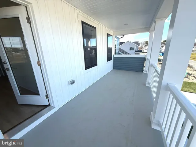 a hallway with furniture and a window