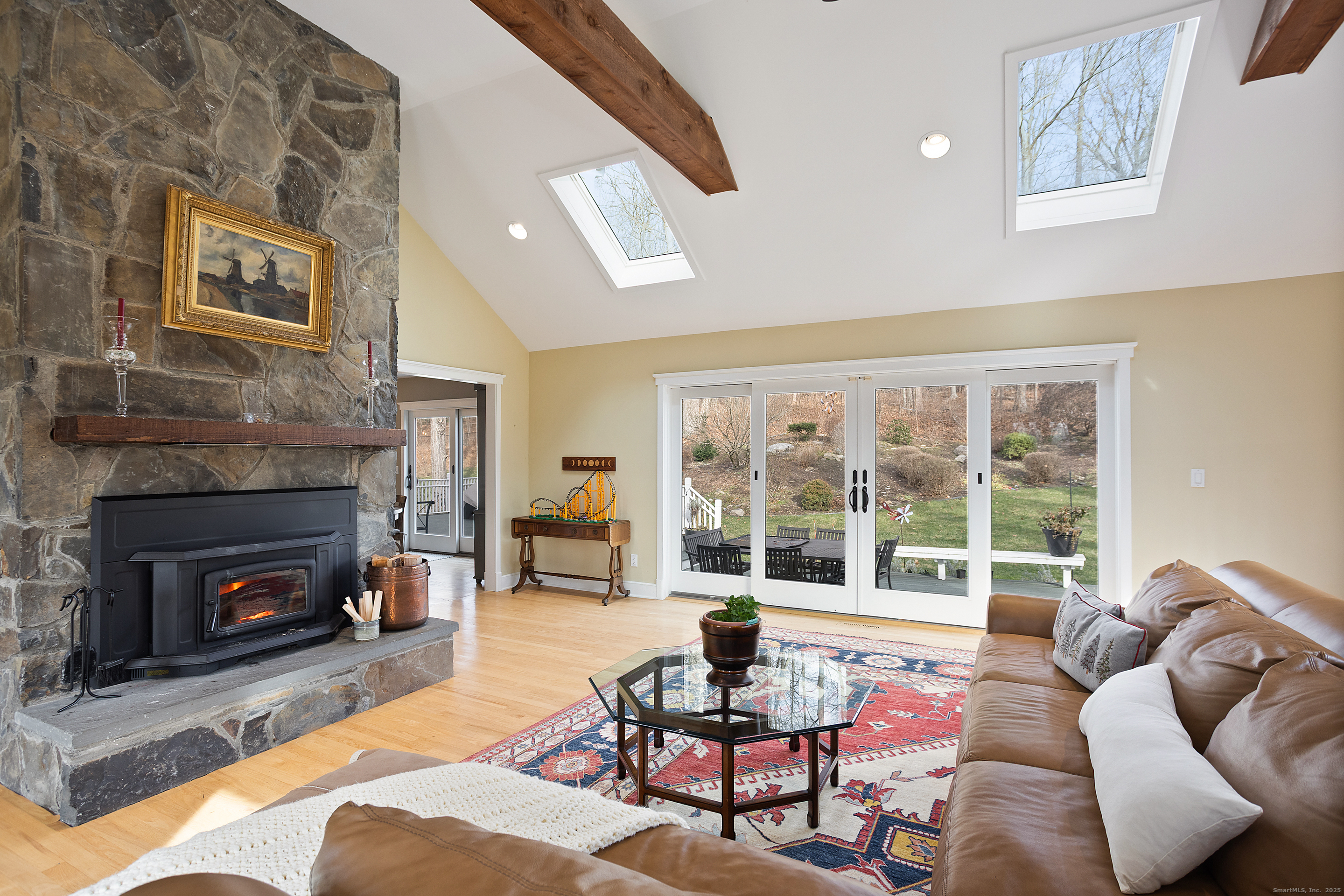 41 Deer Hill Road Redding, CT 06896 - Photo 12 of 31 a living room with furniture a fireplace and a large window