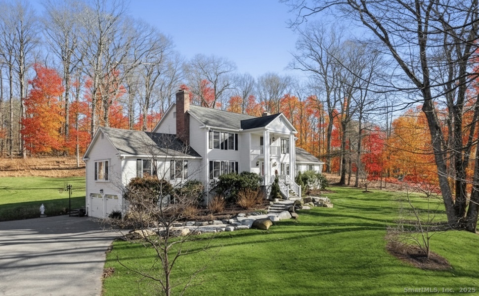 41 Deer Hill Road Redding, CT 06896 - Photo 25 of 31 a front view of a house with a garden and trees