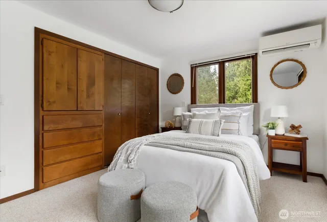 a bedroom with a large bed and a potted plant