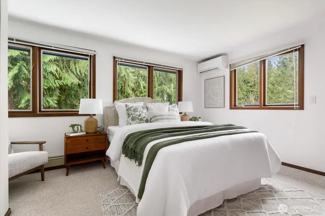 a bedroom with a large bed and a large window