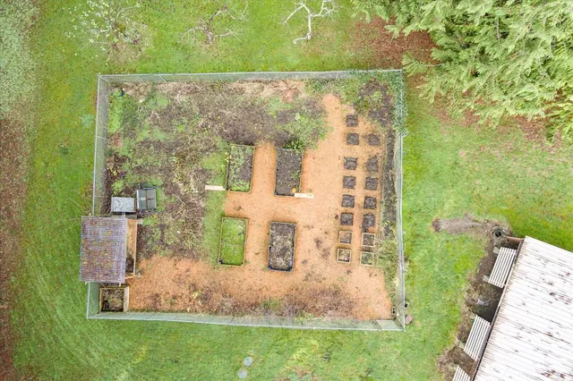 an aerial view of a house with a yard