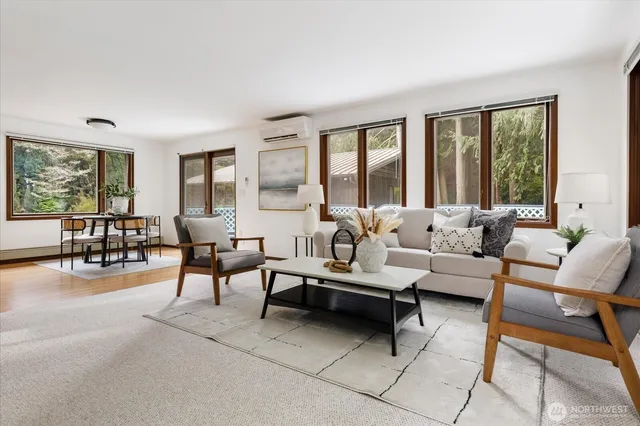 a living room with furniture gym equipment and a large window