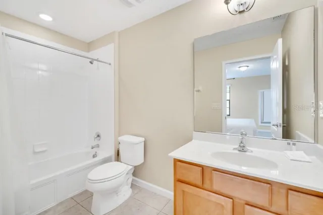 a bathroom with a sink toilet vanity and shower