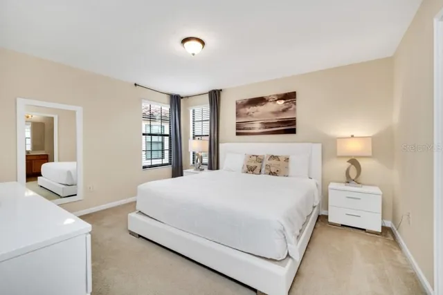 a bedroom with a large bed and a window