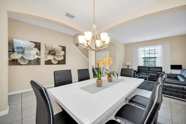 a view of a dining room with furniture and chandelier