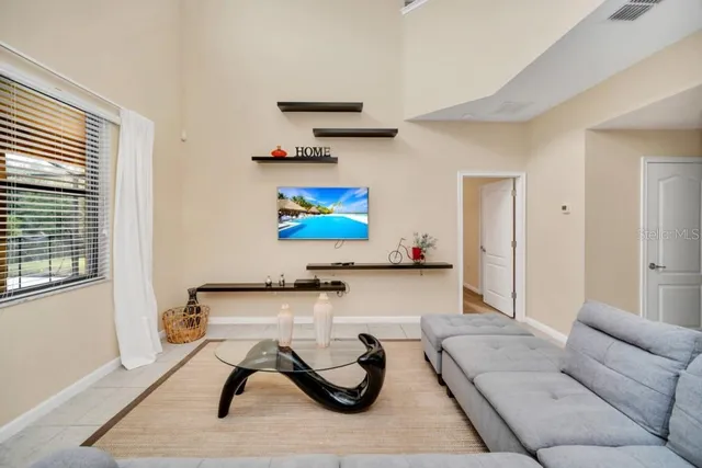 a living room with furniture a rug and white walls