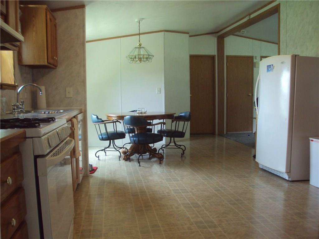 187 Andrusky Road Mercer, PA 16137 - Photo 11 of 15 View of dining area from kitchen notice large opening into living area on the right. Door on the left enters into Bedroom 3 and full bath. Door on the right is to the basement.