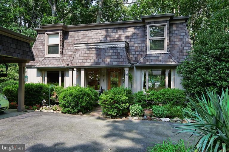 12104 Stirrup Road Reston, VA 20191 - Photo 1 of 27 a front view of a house with a garden