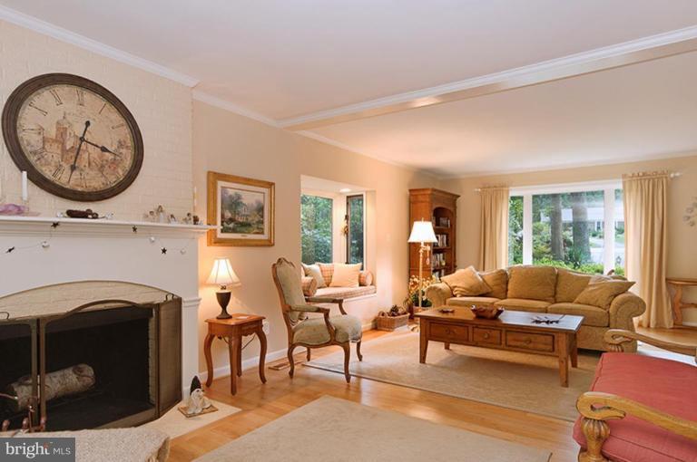 12104 Stirrup Road Reston, VA 20191 - Photo 15 of 27 a living room with furniture a fireplace and a large window