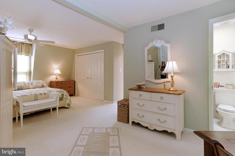 12104 Stirrup Road Reston, VA 20191 - Photo 17 of 27 a bedroom with a bed and a dresser in it