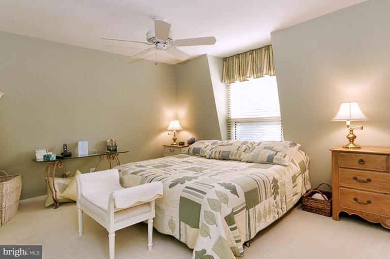 12104 Stirrup Road Reston, VA 20191 - Photo 19 of 27 a bedroom with a bed and a table in it