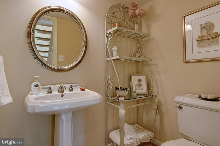 12104 Stirrup Road Reston, VA 20191 - Photo 22 of 27 a bathroom with a toilet sink and mirror