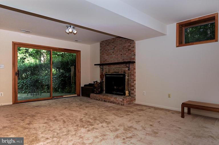 12104 Stirrup Road Reston, VA 20191 - Photo 23 of 27 a view of an empty room with a fireplace and a window